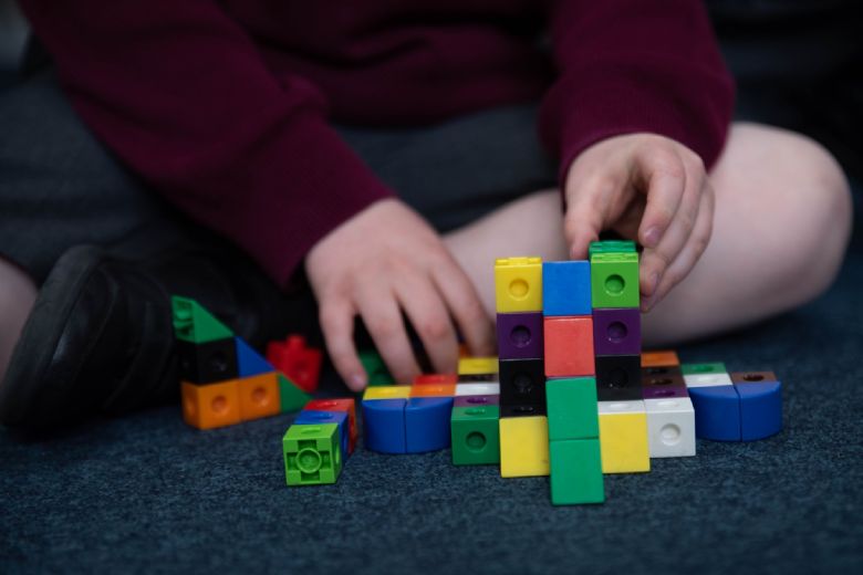 Child building number blocks